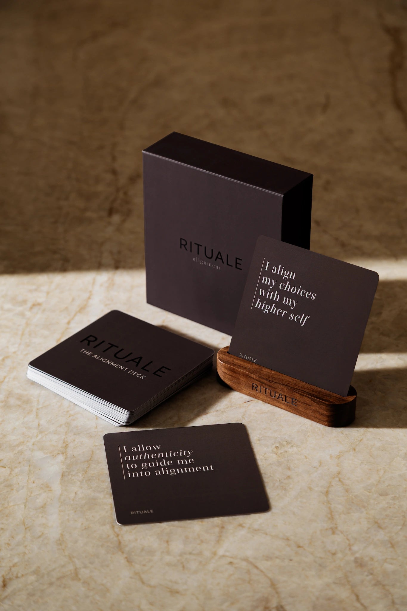 Rituale Alignment Deck with box and wooden card stand displayed on marble surface