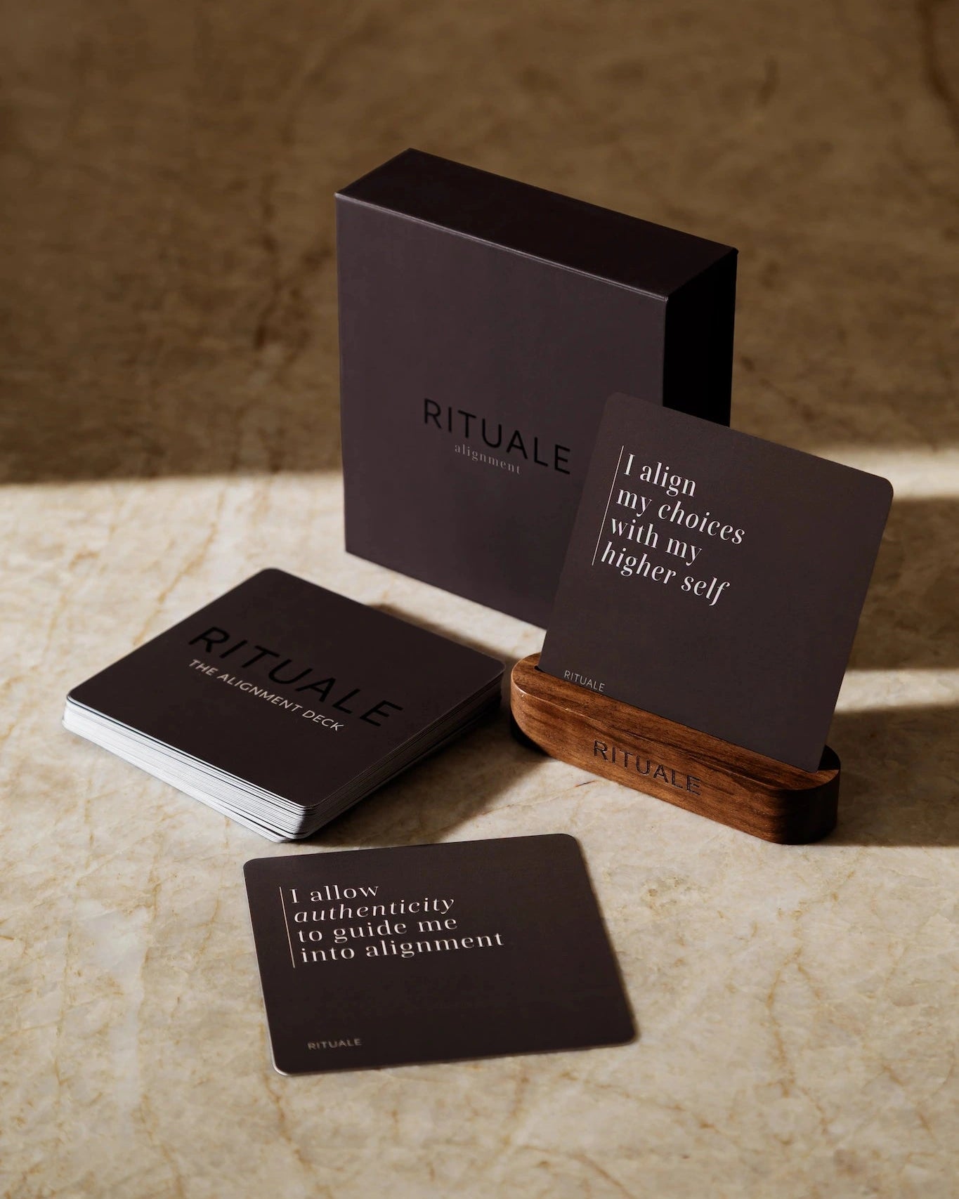 Rituale Alignment Deck with box and wooden card stand displayed on marble surface