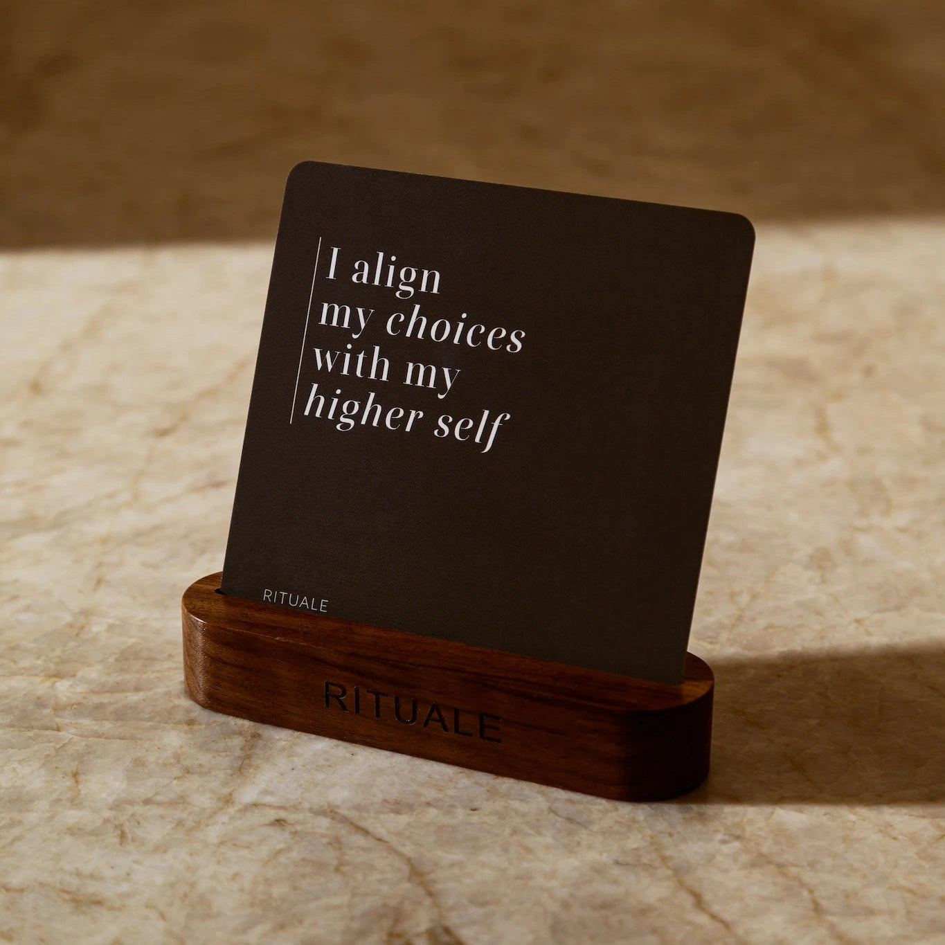 Rituale alignment card displayed in walnut stand reading I align my choices with my higher self