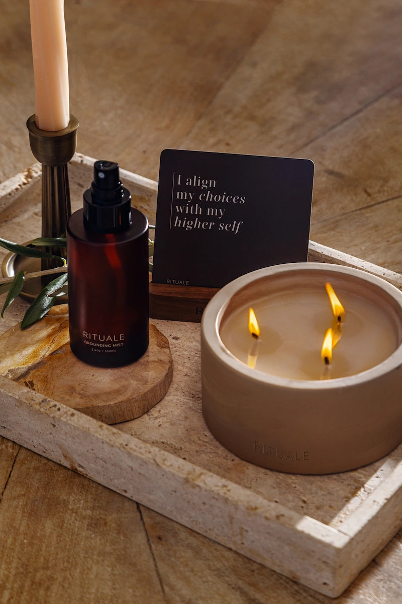 Rituale Grounding Mist, Alignment Deck, and Concrete Candle styled on a travertine tray